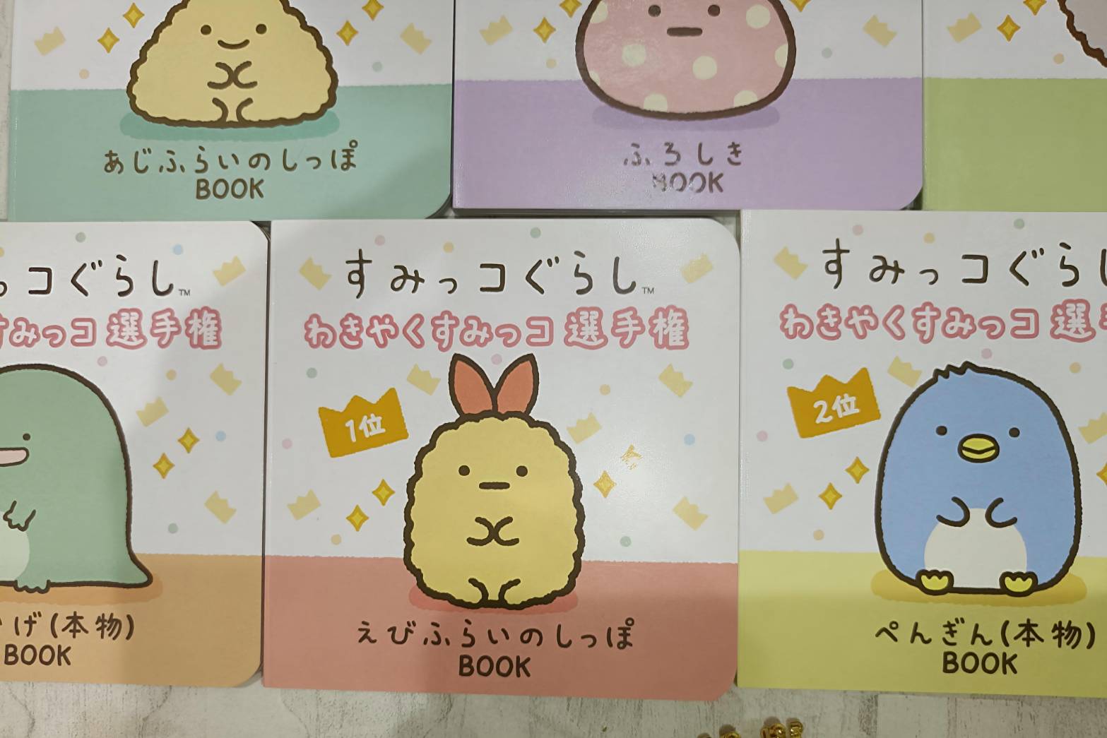 わきやくすみっコ選手権マスコット・青いまるいキャラ（ぺんぎん？）。黄色衣装・黄緑石の王冠・ゴールドビーズチェーン・7thメダル付き